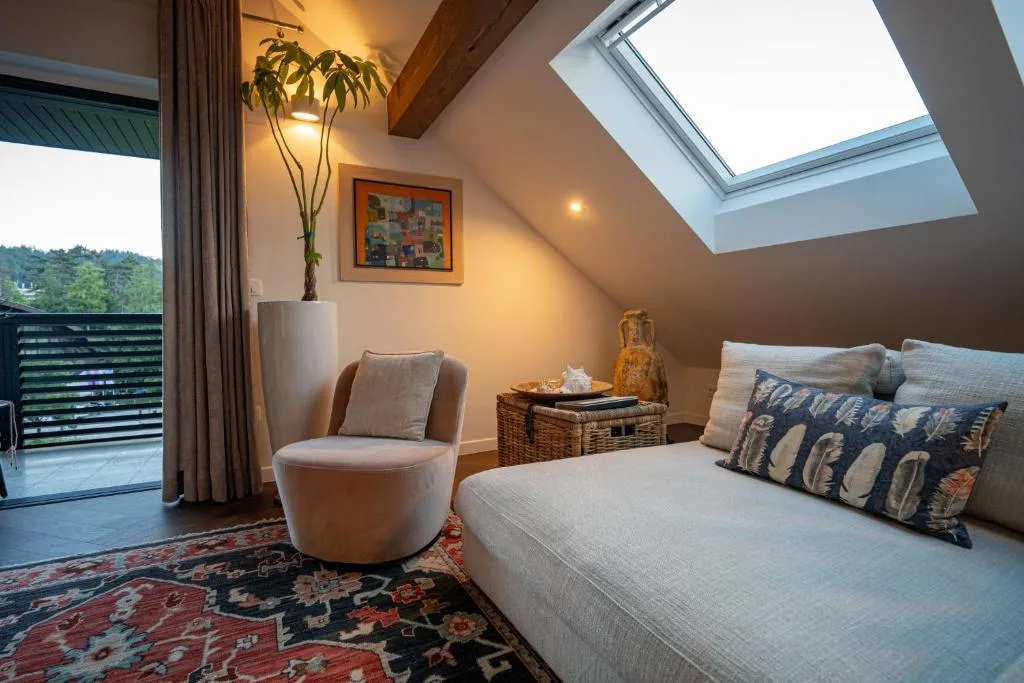 Double bedroom with warm lighting and wooden floors at Maxis Penthouse Bled