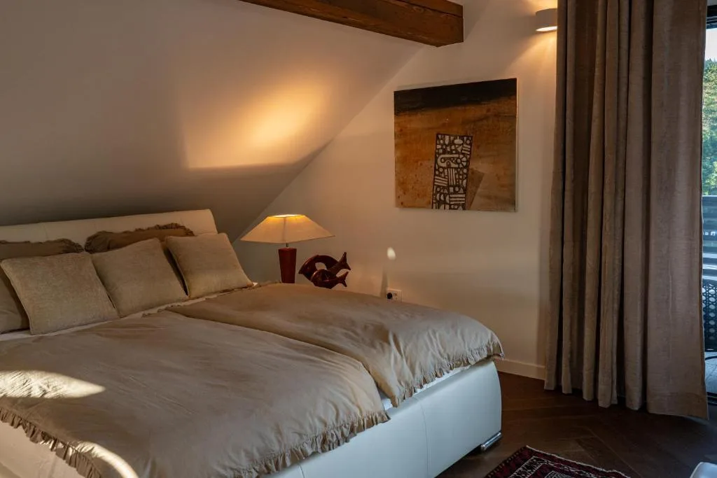 Bright living area with wooden floors and roof windows at Maxis Penthouse Bled