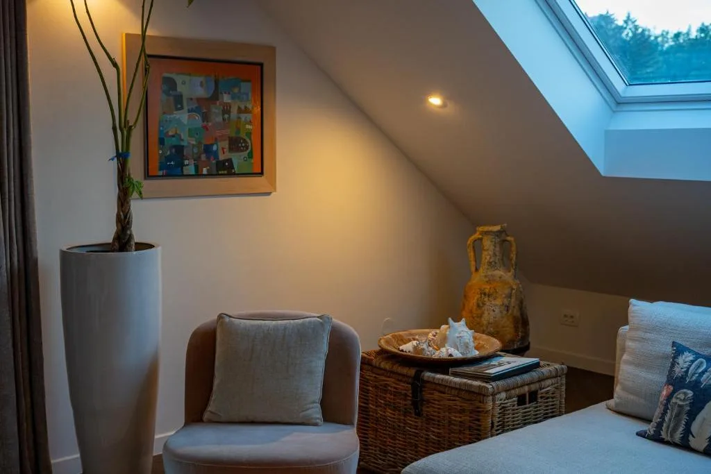 Living room with balcony door and garden view at Maxis Penthouse Bled